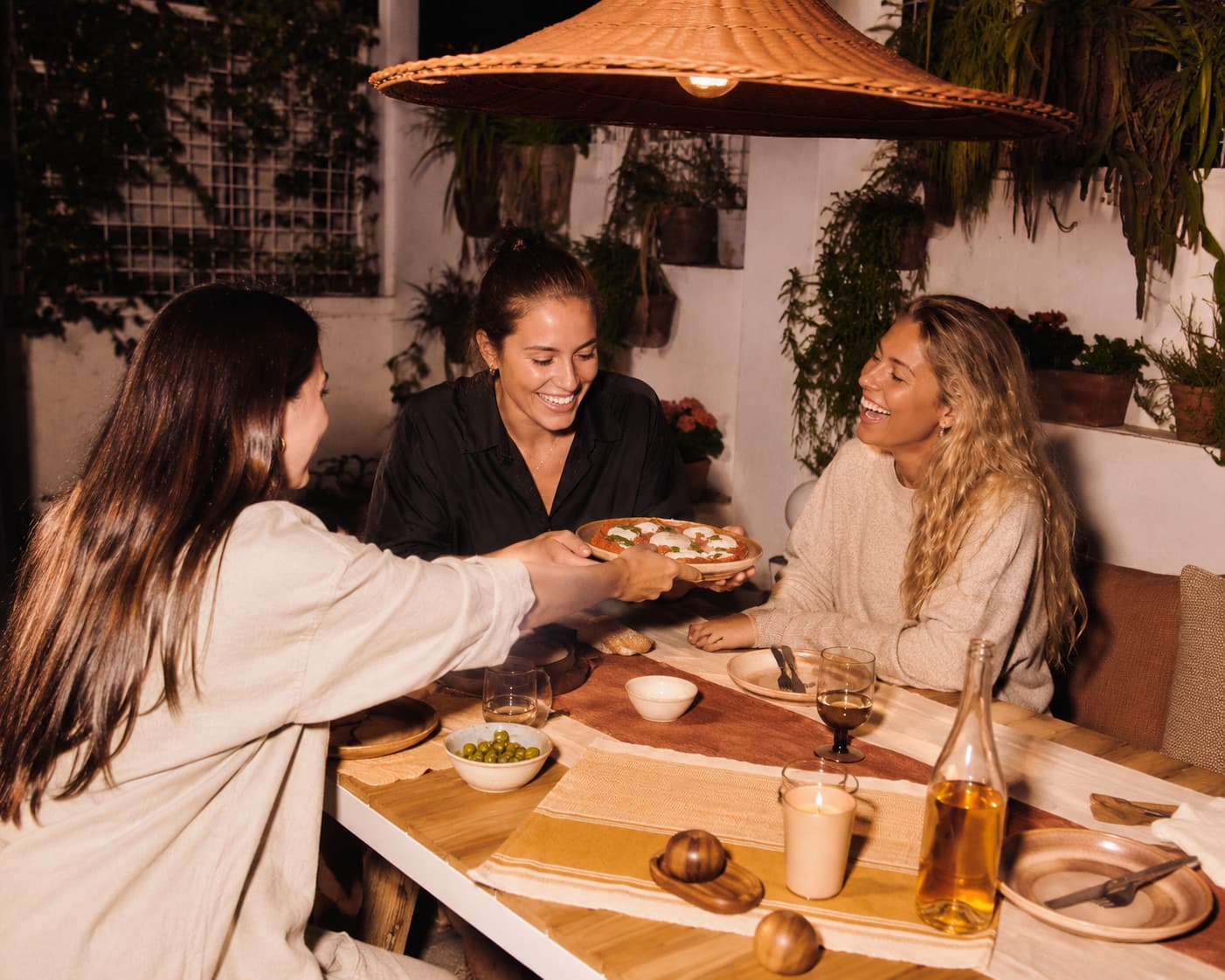 Friends sharing an evening meal on a green terrace