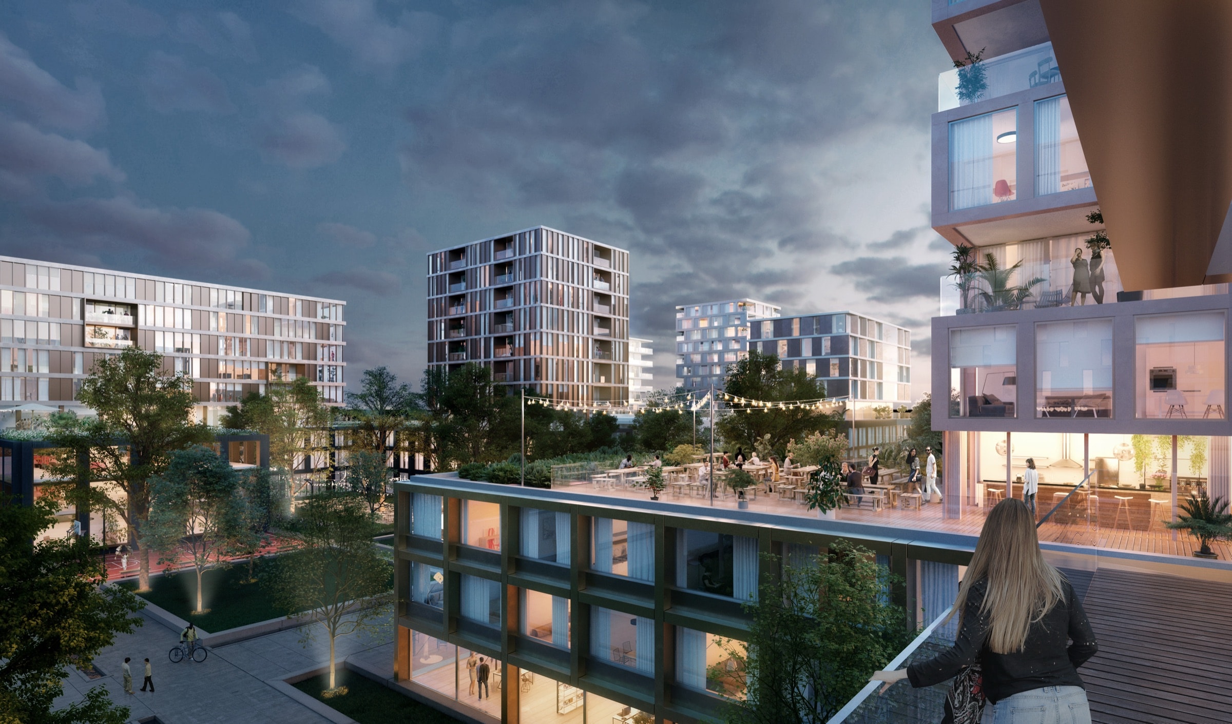Evening impression of the MORE courtyard with its lit roof terrace