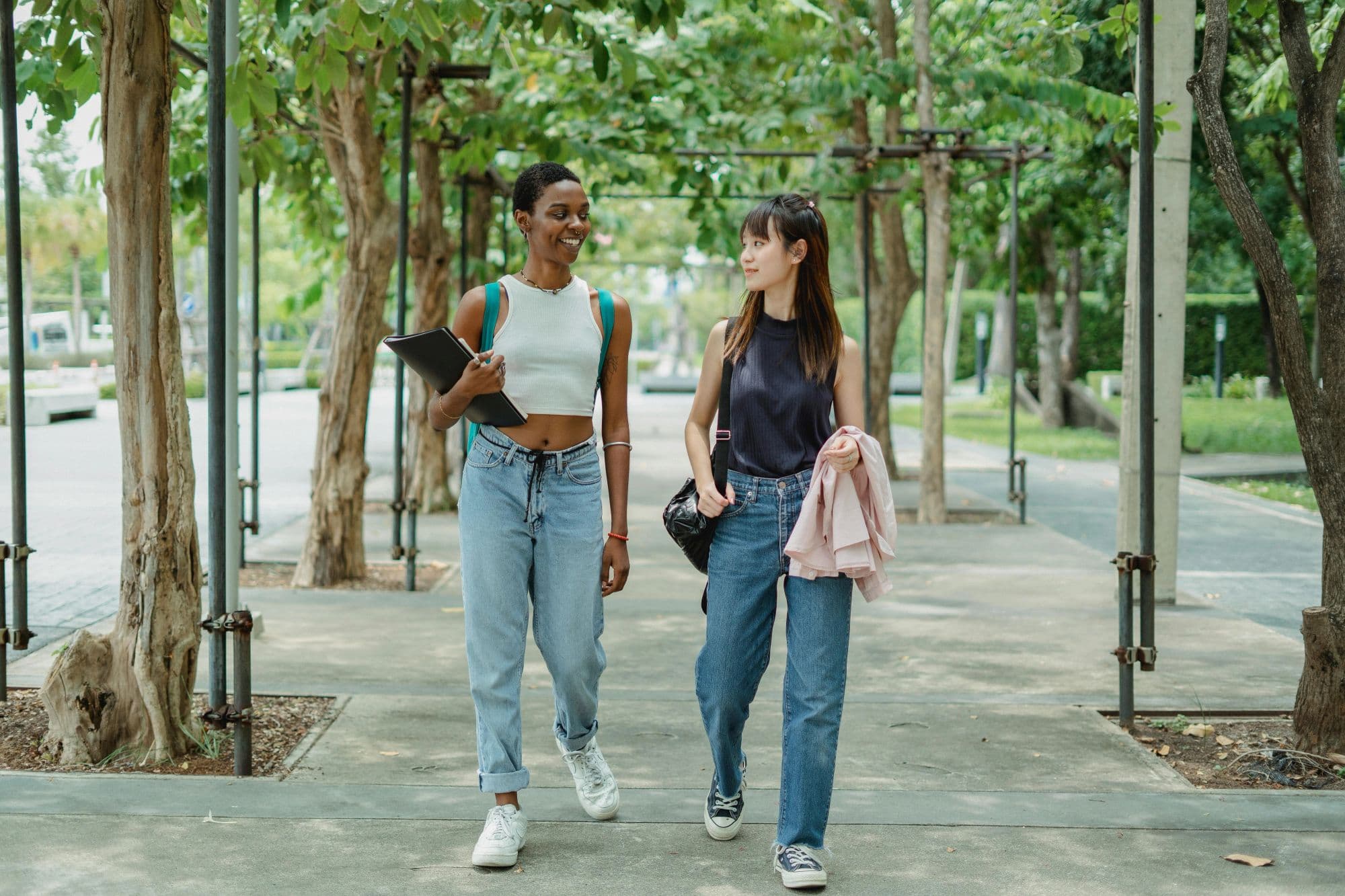Two residents walking through the greenery of Park MORE